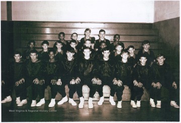 Coach "Buck" Porterfield's basketball team posing in the school gymnasium.