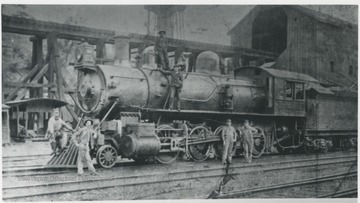 Samuel Irwin leaning on front of the engine. Charles Boley on the running board. 
