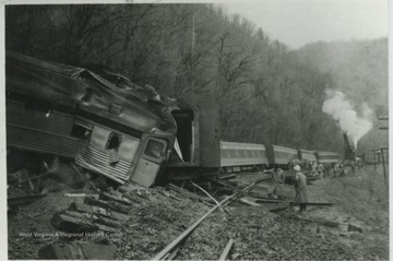 A group examines the damage of the wreck along the C&amp;O railroad. 