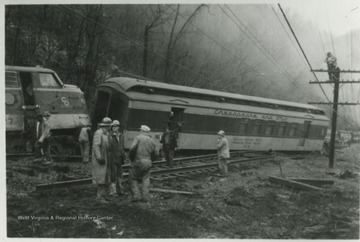 Unidentified workers examine the damage along the C&amp;O railroad.
