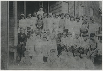 School teacher and students gather for school photo. Subjects unidentified. 