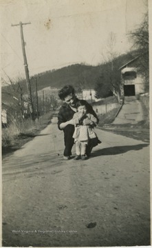 Corrine Bryson Smith and her daughter pictured in the street. 