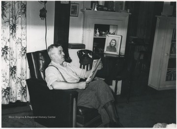 Keller pictured reading in his chair inside his home at 112 Greenbrier Drive near Hinton, W. Va.