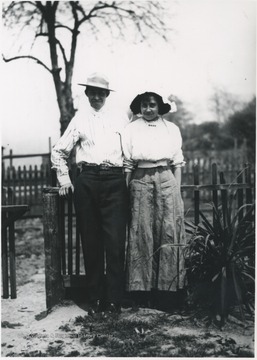 The photographer's uncle and wife are pictured in front of the fence.