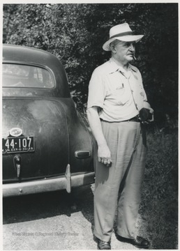 Keller stands beside his automobile at 112 Greenbrier Drive near Hinton, W. Va.