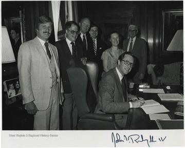 Rockefeller pictured signing the West Virginia Real Estate License Law. The photograph is autographed by the governor. 