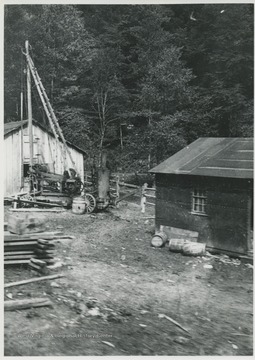 Photo showing drilling equipment and work shed.