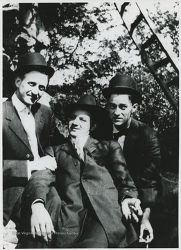 The three men pose for the group portrait. 