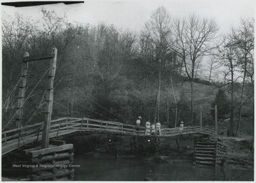 A group of unidentified women pictured on the wooden bridge. 