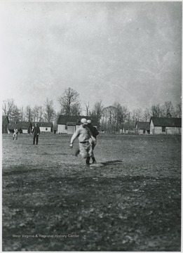 A player runs to base. Subjects unidentified. 