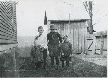 Four unidentified children pose in the yard.