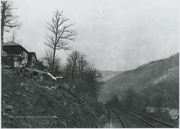 Houses on the left overlook the tracks and the river. 