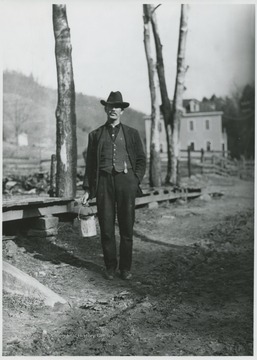 An unidentified man carrying a paint bucket is pictured just outside the school grounds. The school was established in 1909.