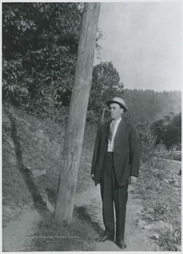 Cook pictured beside a wooden post.