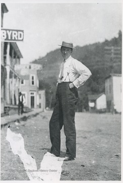 An unidentified man poses in the street. Hotel Byrd sign partially pictured on the left. 