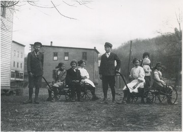 A group of young people sitting on wagons.