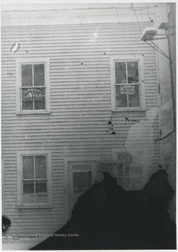 Signs in the windows read "Thos H Scott Lawyer" and "H.P. Burnett Attorney at Law".