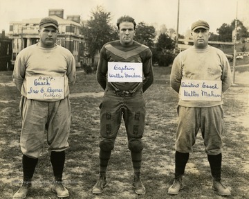 Print number 129a. (Left to right): Assistant Coach Ira Rodgers, Captain Walter Gordon, and Assistant Coach Walter Mahan.