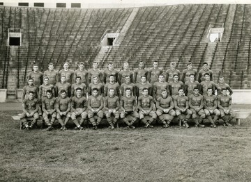 Print number 170. Mountaineer team from left to right: (Back row): Parriott, Dotson, McDermott, Baker, C. White, Karr, Sortet, Sprouse, Hamilton, Lough, Sowers, and Sebulsky. (Middle row): Ferrara, Schwartzwalder, Anderson, Drobeck, Stone, Lewis, Covey, Wright, Schweitzer, McCracken, Brown, Carden, and Canich. (Front row): Marker, Carpenter, Dreppard, Johnston, Forte, Zirbs, Captain Doyle, Haddock, Beall, J. Fizer, Mazzei, H. Fizer, and H. White.