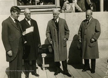 Caption on back of photograph reads: "Dr. Carl Reiland of St. George Church, delivering the invocation at the dedication of the new Doctor's Hospital at East End Avenue at 88th Street. Left to right in the picture beside Dr. Reiland, are: Thomas Cochran, of J.P. Morgan and Company, President of the hospital; John W. Davis, former Democratic Candidate for President, who laid the cornerstone; and Dr. Alexander Lambert, member of the Board of Directors."
