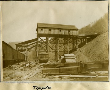 Tipple stands below the mine, with lumber next to it.  