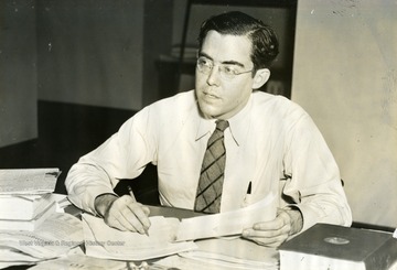United States Senator Rush D. Holt from Weston, West Virginia, pauses while working at his desk.