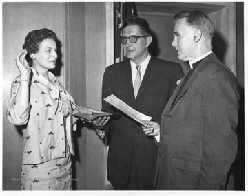 Helen Holt swearing in to new job at FHA.  Dr. Frederick Brown Harris is pictured as well, along with a Methodist Church Chaplin. 