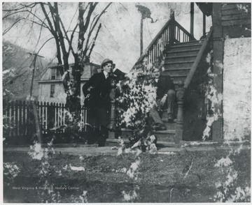 Murrell pictured leaning on the porch steps of his home located on the corner of Summers Street and 5th Avenue. Man sitting on the steps is unidentified. 
