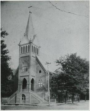 The Catholic Church building located on 2nd Avenue & Temple Streets. Note the boardwalk and dirt streets. Brick roads were not laid until around 1907.