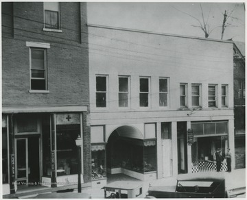 The building, located on Temple Street, is home to many stores including Dr. Abott's Dentisttry (pictured on the right) and a drug store (pictured on the left). Alderson-Shumate Bootery pictured in the center.  