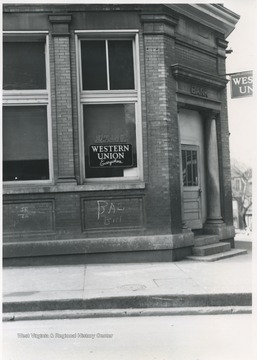 View of the building from the street. Window advertises West Union and Dr. J. W. Stokes office. 