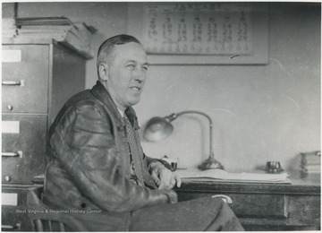 Keller pictured sitting at his desk. 