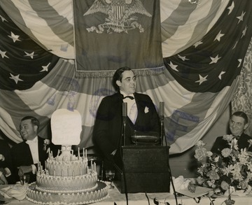 Senator Rush D. Holt (center), of West Virginia, speaking at a dinner of The Bronx Real Estate Board, at the Hotel Commodore, March 18, at which time he told of the need for curtailing unnecessary Government spending. Henry G. Altemade, President of the Bronx Real Estate Board, is shown left; James J. Lyons, Bronx Borough President, is shown right.