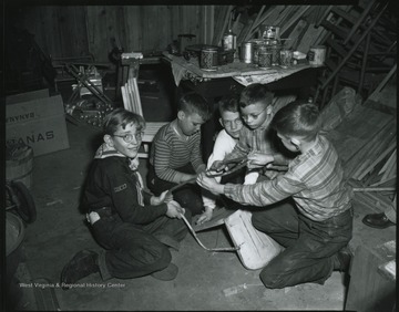 Cub Scout boys help fix toys for the less fortunate in time for Christmas with the Hinton Fire Department. Subjects unidentified. 