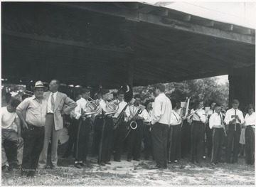 Young musicians play their instruments in the camp's pavilion. The man in the suit and tie is Irvin S. Maddy, the superintendent of Summers County schools. 