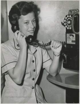 Dick pictured on the telephone. She was a member of the Women's Army Corps (WAC).