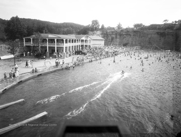 Rock Lake Pool in South Charleston, West Virginia was built from an old rock quarry which was in operation in the 1930's. The pool was opened up by the Wilan family in 1942 and it remained in operation until 1985. The pool was surrounded by high natural rock walls, which provided perfect opportunities for high dives and swings. It also included a 50 foot slide, water trampoline, fountain, and trapeze. It closed down due to competing pools in the area which offered cheaper prices.