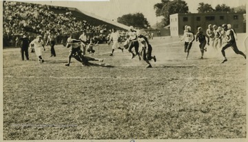Billy Joe Lilly pictured running with the ball. The Bobcats, a semi-pro football team, won this game with the final score at Hinton-9, Charleston-6.