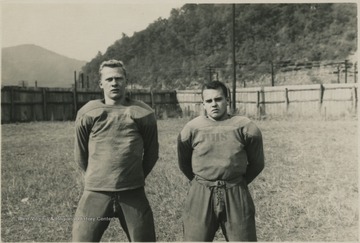 Kyle Gwinn,right, and Howard Williams,left, pose together on a field. 