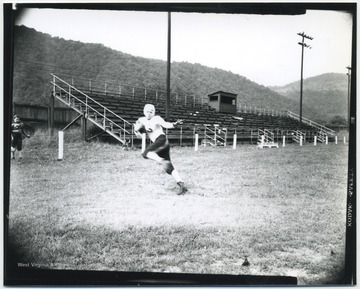 Shires, a football player for the Hinton High School Bobcats, pictured running with a football.