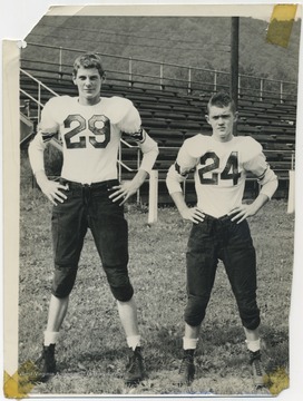 Dick Gunnoe, left, and David Hess, right, pictured in their team uniforms in front of the bleachers. 
