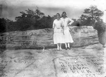 Location is probably at the main overlook of Coopers Rock State Forest.  Many names, initials, and phrases are written on the rock including "Camp Smooch".