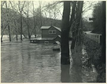 Kozy Kove, a family camp, is pictured mostly submerged in flood waters. To the right is Route 3.