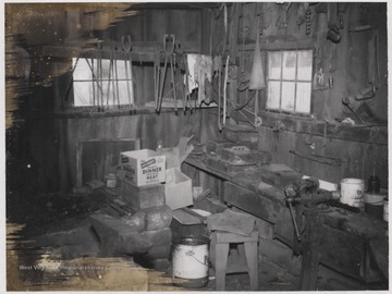 Reverend William W. Hicks shop built ca. 1884. Blacksmith equipment and supplies are pictured within the building.
