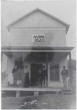 W.M.A. members and woman pictured on the store's front porch. Subjects unidentified. 