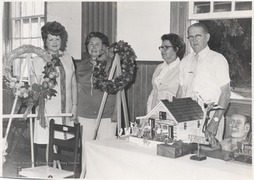 Pictured from left to right is an unidentified woman, Virginia Vaughn, Mrs. S. L. Jones and S. L. Jones.Jones was a well-known folk artist and wood sculptor. 
