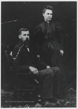 The sitting reverend and his wife pose at Jumping Ranch area. 