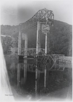 Part of the bridge fell during its construction in 1948. Steel pieces sit in the mouth of the Bluestone River. 