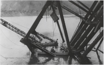 Five workmen killed and four injured when the 300-ton span buckled and folded downward into the river. A week after the collapse the men began dismantling the twisted span, using a never before used technique by burning the steel beams with chemicals.