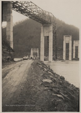 Ground view of the disaster.Five workmen killed and four injured when the 300-ton span buckled and folded downward into the mouth of Bluestone River.A week after the collapse the men began dismantling the twisted span, using a never before used technique by burning the steel beams with chemicals.